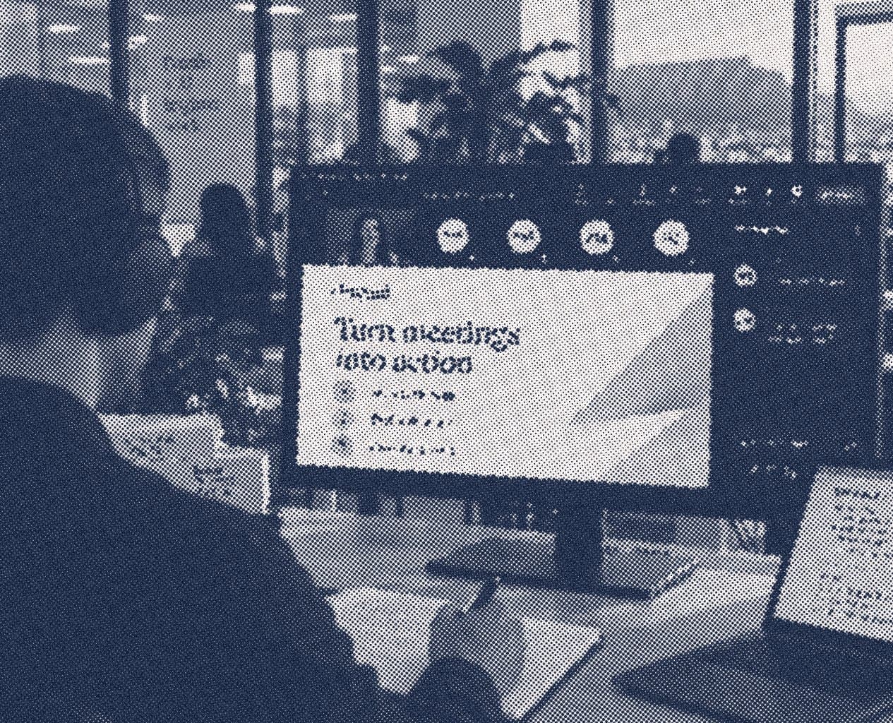 A remote workshop session shown on a monitor, running alongside an in-person session